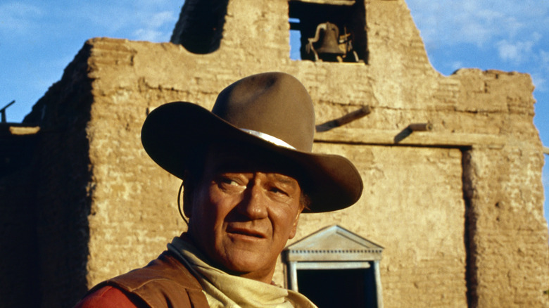 John Wayne poses in front of Alamo movie set, 1964