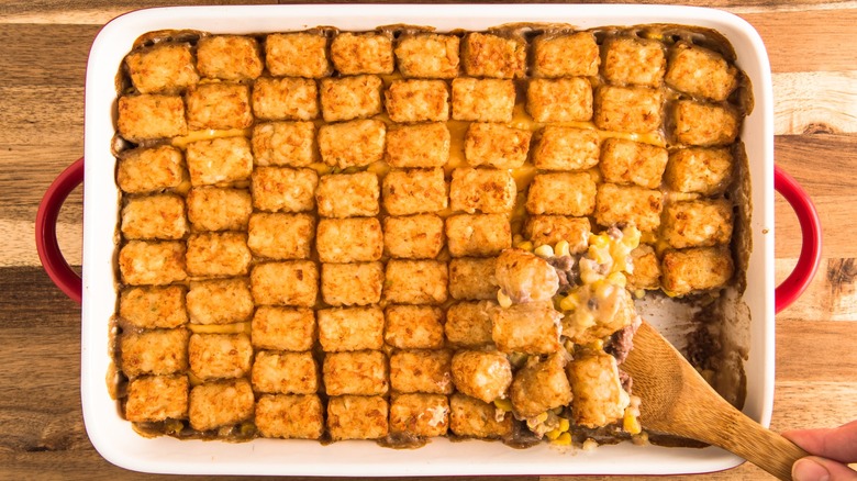 tater toyt cowboy casserole with wooden spoon