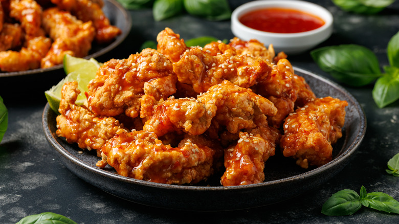 Korean fried chicken with spicy sauce and sesame seeds