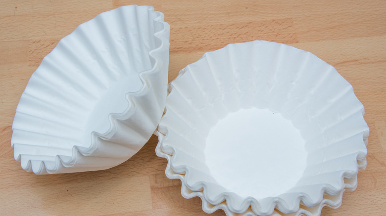 stacked coffee filters with wood grain background
