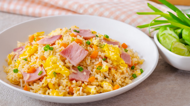 A white bowl of fried rice with ham