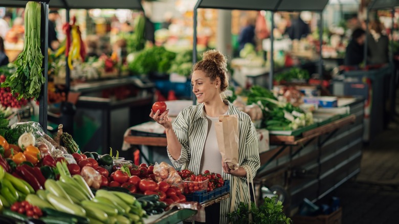 female shopper is surrounded by fresh produce