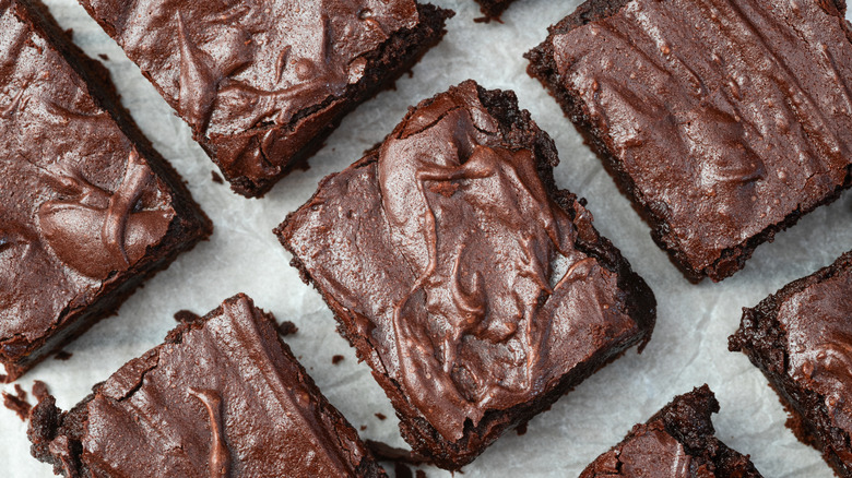 Brownies on parchment paper, overhead shot.