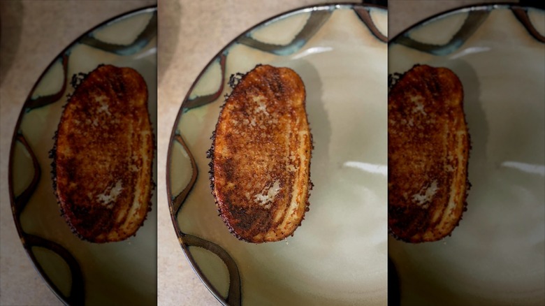 paremsan crusted baked potato on pretty dish
