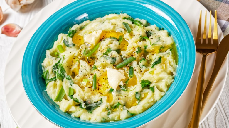 buttery colcannon in blue bowl with fork