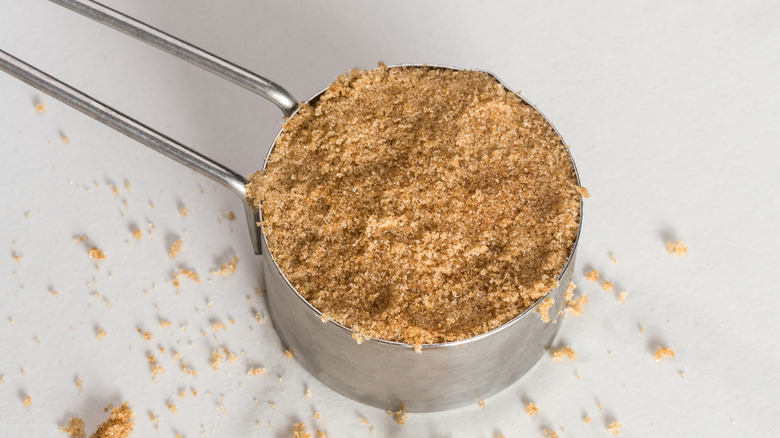 Packed light brown sugar in a measuring cup. 