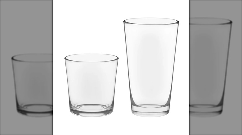 tall and short glass tumblers with white background