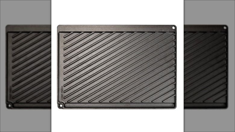 black cast iron griddle pan on white background