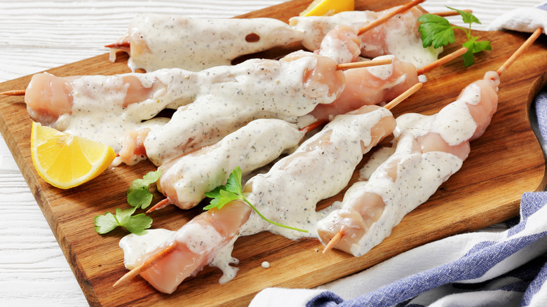Raw chicken covered with yogurt and seasoning