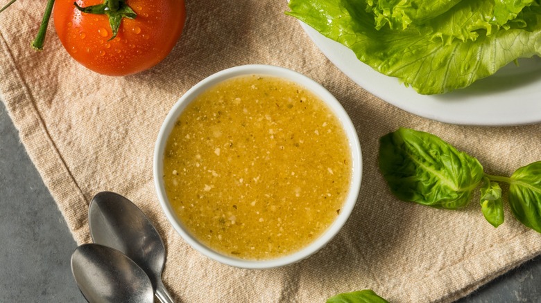 small bowl of italian dressing with salad ingredients
