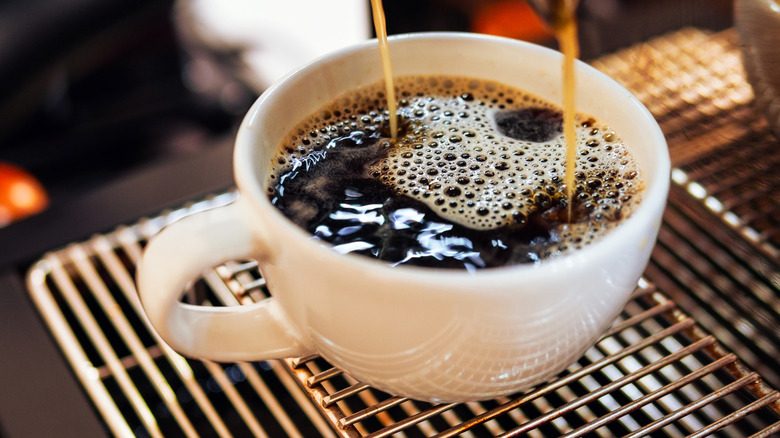 Close-up of Americano pouring into a cup