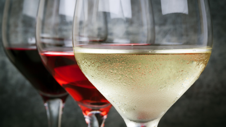 Close-up of glasses of white, rose and red wine