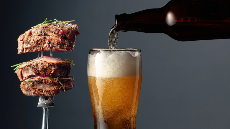 Beer and grilled ribeye beef steak with rosemary