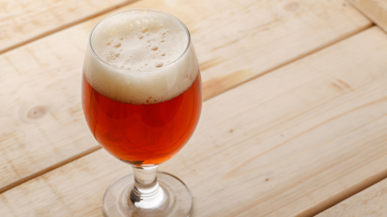 Glass of red ale beer on a wood table
