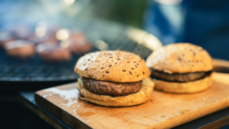 fresh homemade burgers by bbq grill