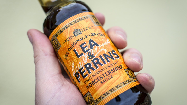 Someone holding a bottle of Lea & Perrins' Worcestershire sauce