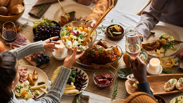 Overhead shot of Thanksgiving meal being shared by group at a table.