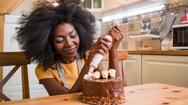 woman decorating cake