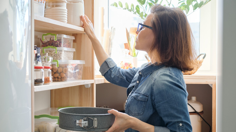woman checking pantry for ingredients