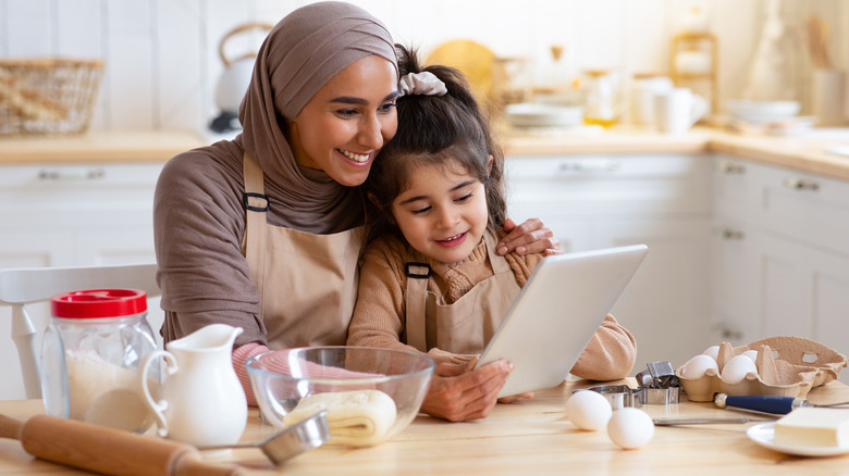 mother and daughter reading cake recipe