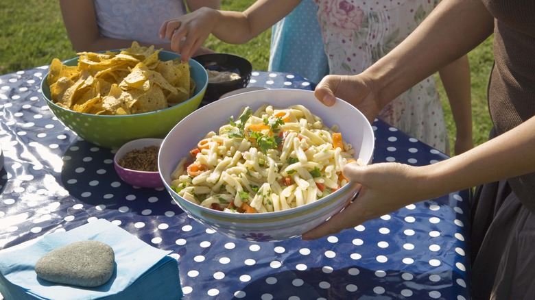 putting pasta salad out at picnic