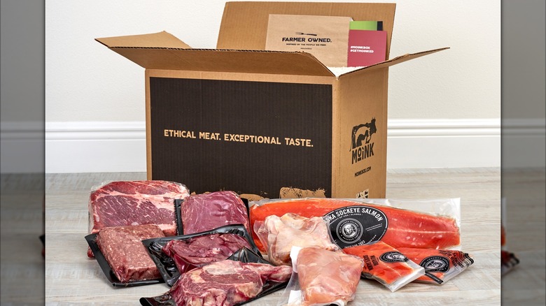 A Moink Box is surrounded by its contents