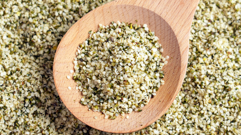 closeup of hemp seeds in wooden spoon