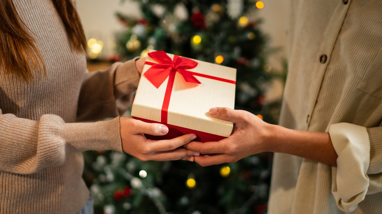 A close-up of a gift someone's handing to another person