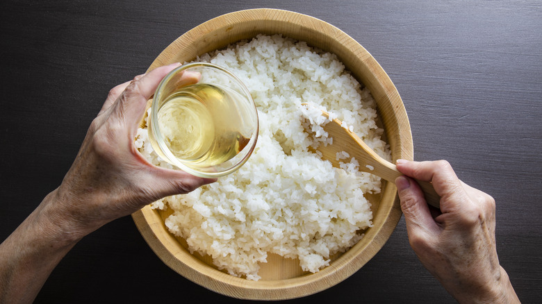 Pouring rice wine vinegar over rice