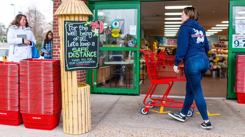 trader joe's employee pushing a cart