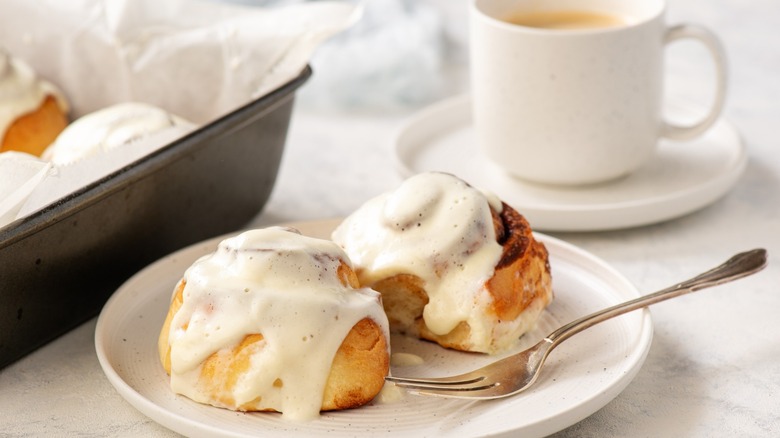 traditional american cinnamon rolls with icing and fork