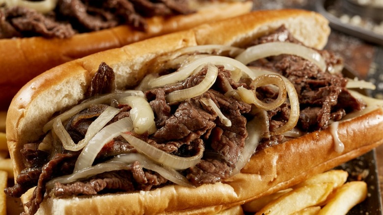 close up of cheesesteak sandwich with sliced onion