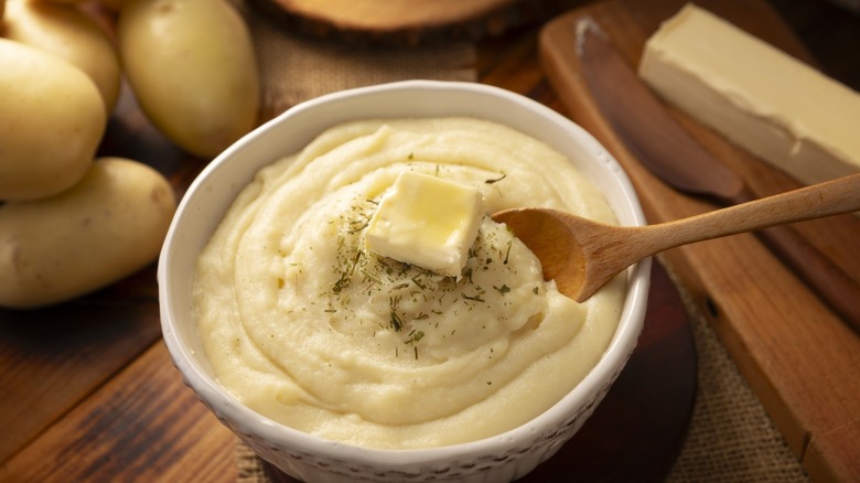 mashed potatoes in bowl with butter pat