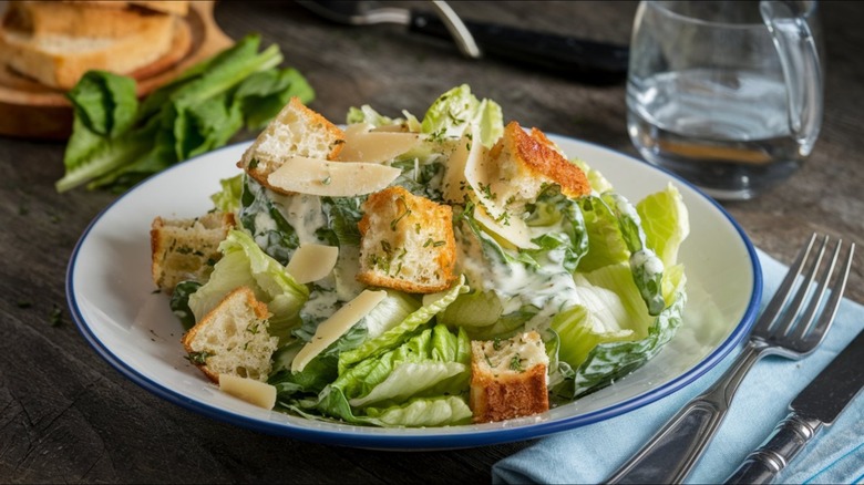 caesar salad on a place setting at table