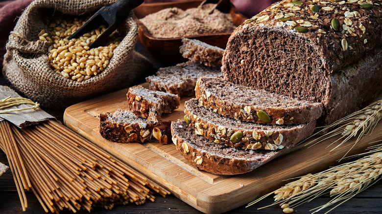 Wholegrain sliced bread and wholegrain pasta on a board