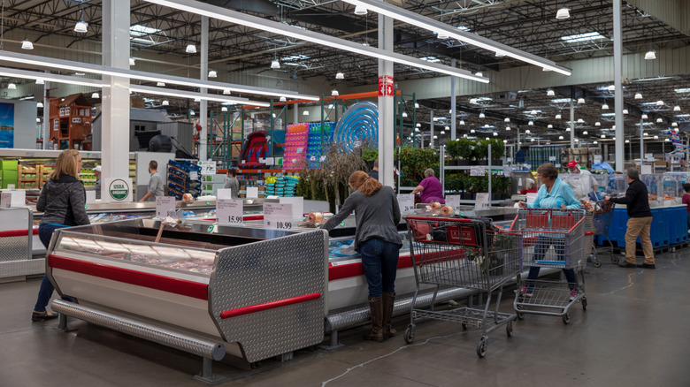 Shoppers browse Costco cold cases inside store