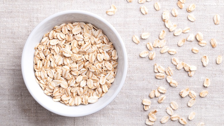 bowl of scattered oats on natural surface