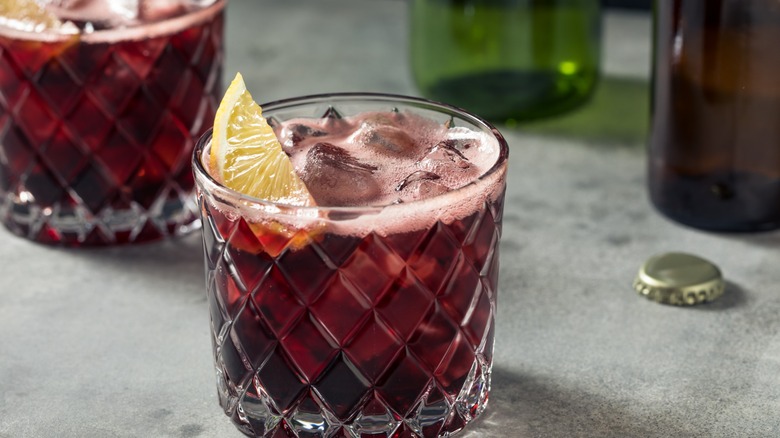 red wine and cola cocktail with lemon