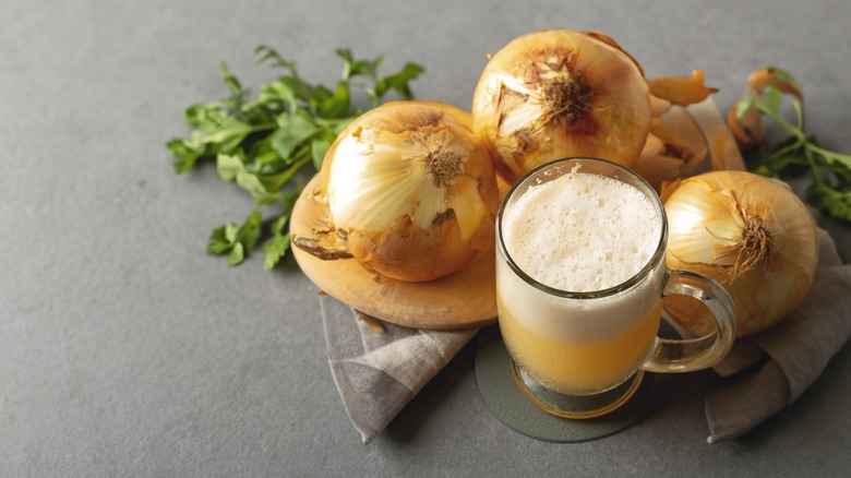 whole onions with foamy cup of onion juice