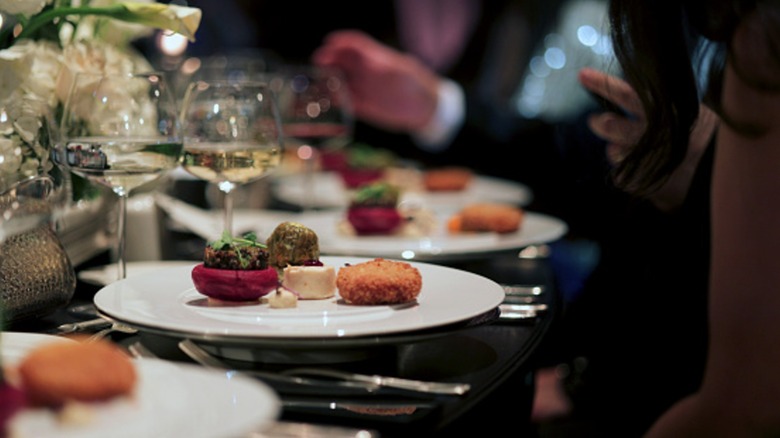diners enjoy a luxury dinner with wine
