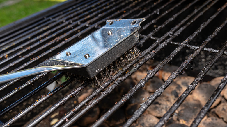 Cleaning a dirty grill with a wire brush