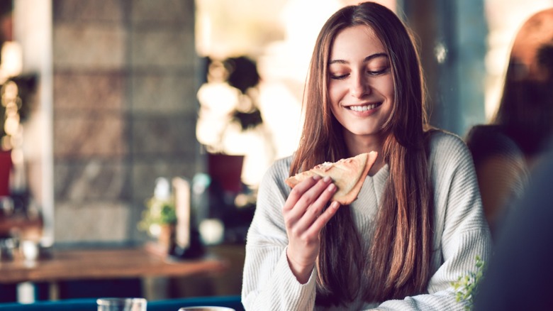 girl holds grilled cheese sandwich
