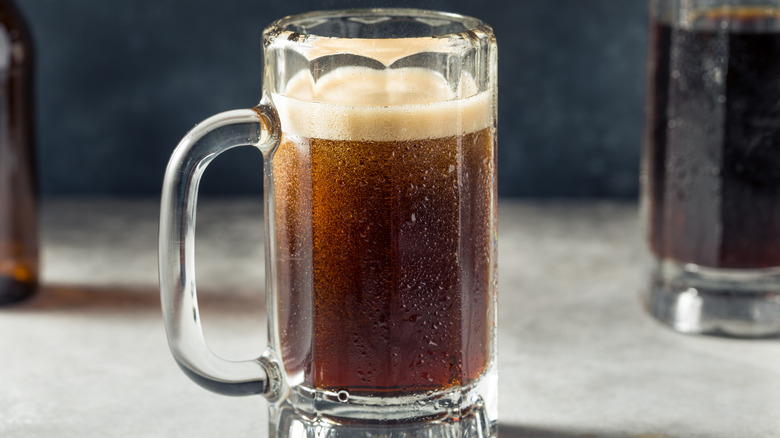 A close-up of a full mug of root beer soda