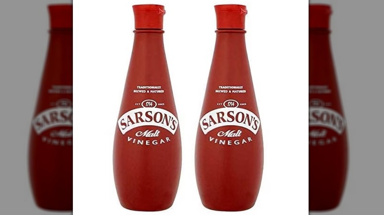 Two bottles of Sarson's malt vinegar on a white background