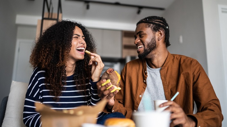 happy couple enjoys fast food lunch