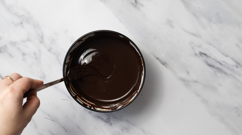 Mixing melted chocolate in bowl