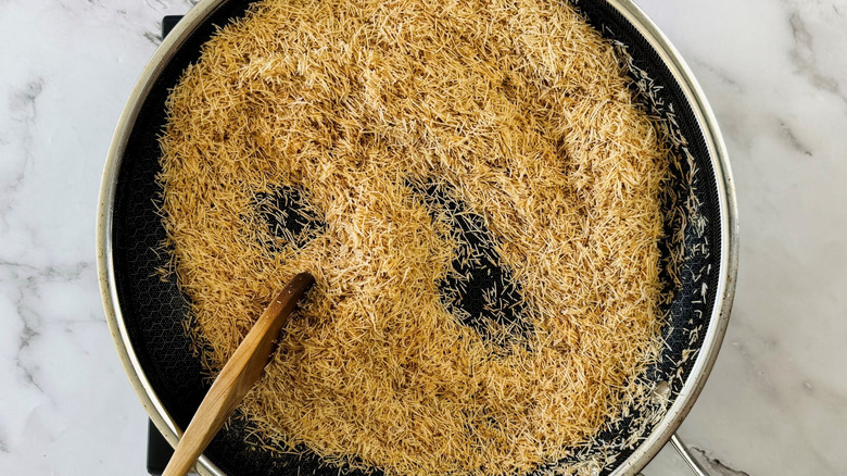 Toasted kataifi in pan with wooden spoon