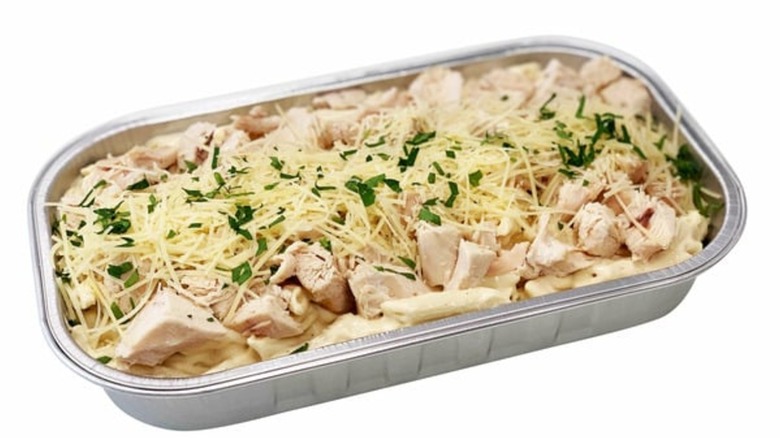 kirkland signature chicken alfredo with penne on white background