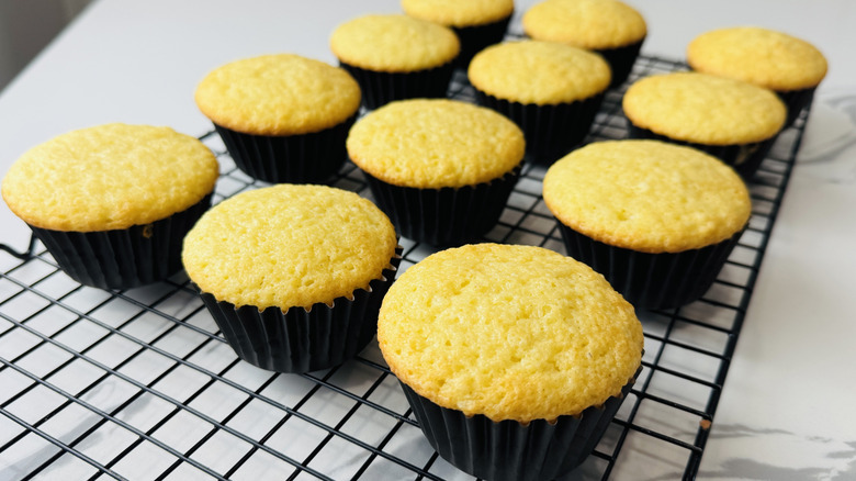 yellow cupcakes on a wire rack