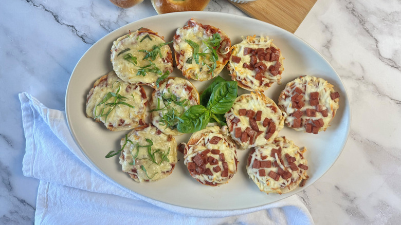 pizza bagel bites on platter next to cloth